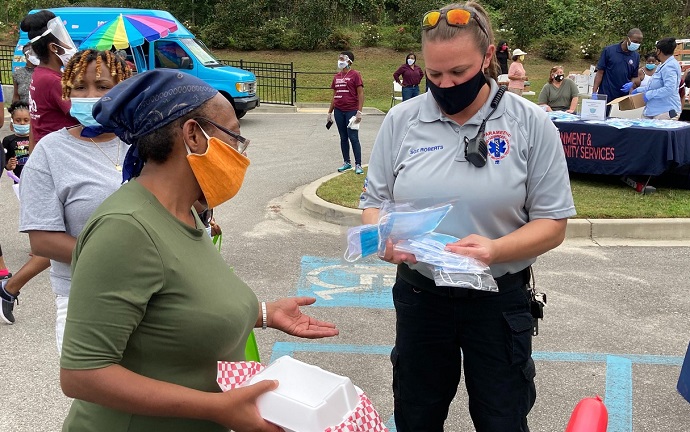 A Richland County employee hands out face coverings at a recent distribution event. A Richland County employee hands out face coverings at a recent distribution event.