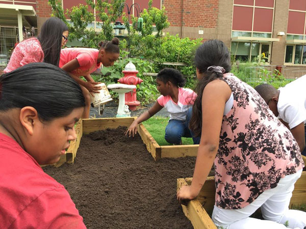 Students prepare a raised bed garden at Catawba Trail Elementary School