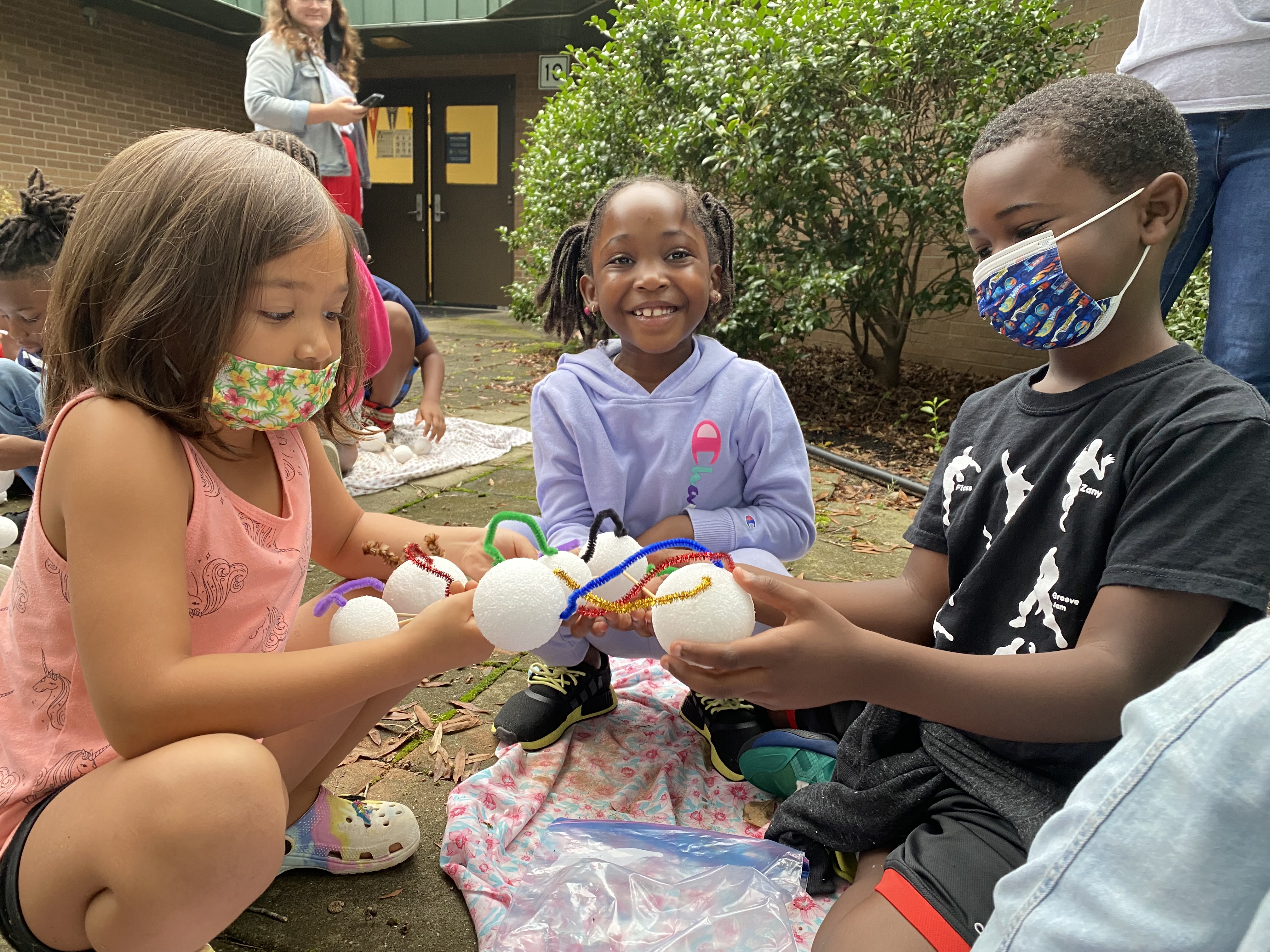 Students construct a soil model using styrofoam balls and pipe cleaners.