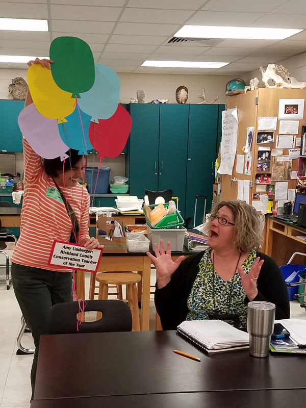 Amy Umberger (right) is surprised with a bouquet of paper balloons Amy Umberger (right) is surprised with a bouquet of paper balloons