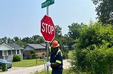 stop sign installation at neighborhood intersection
