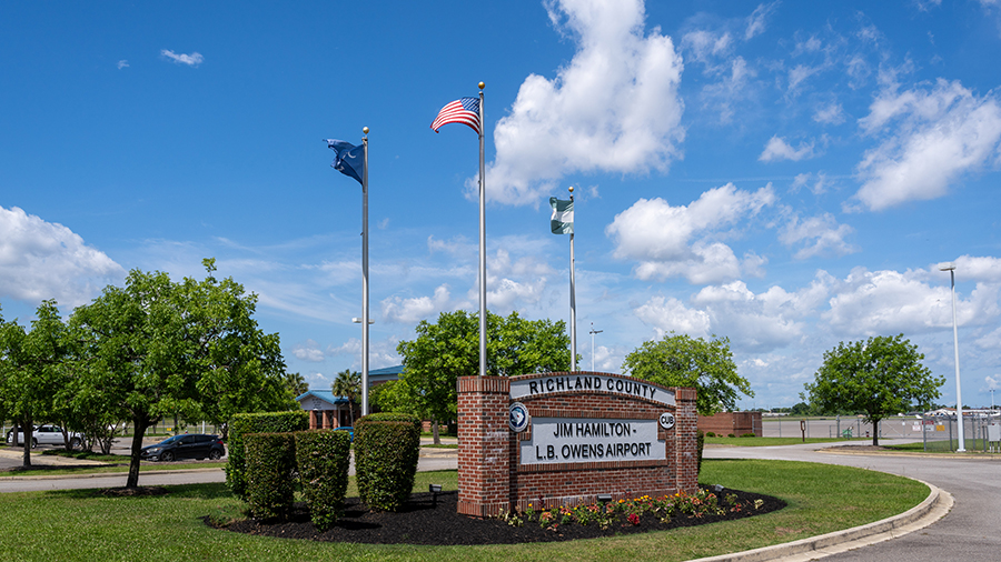 airport entrance sign and flags