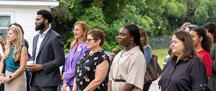residents attend an outdoor groundbreaking for MIRCI